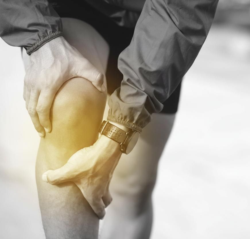 Person holding a painful knee
